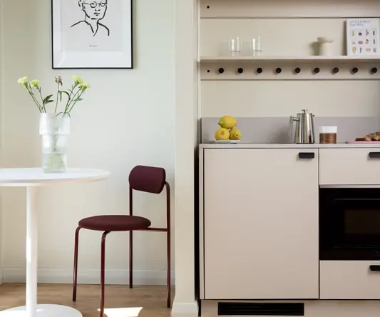 a kitchen with a table and a chair