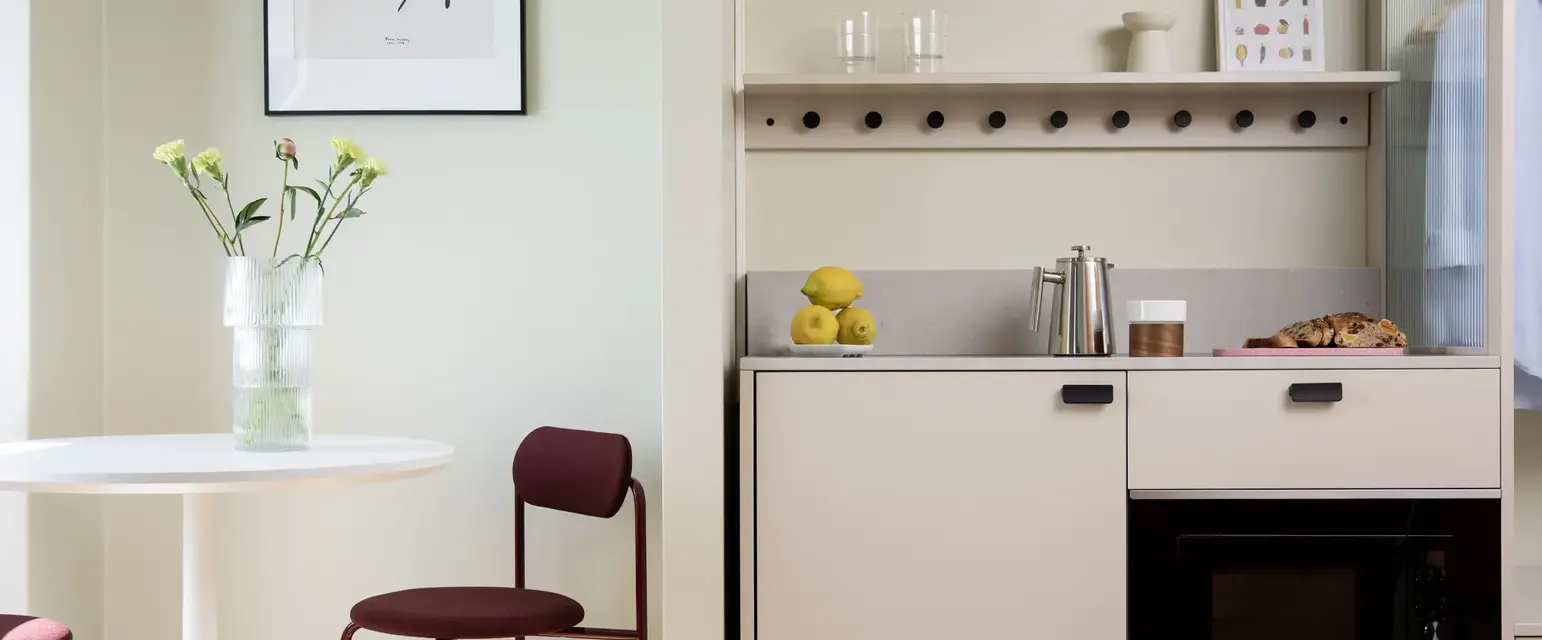 a kitchen with a table and a chair