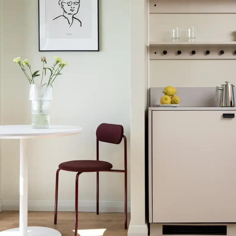 a kitchen with a table and a chair