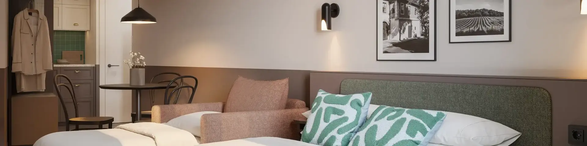 a bed with pillows and a chair in a room