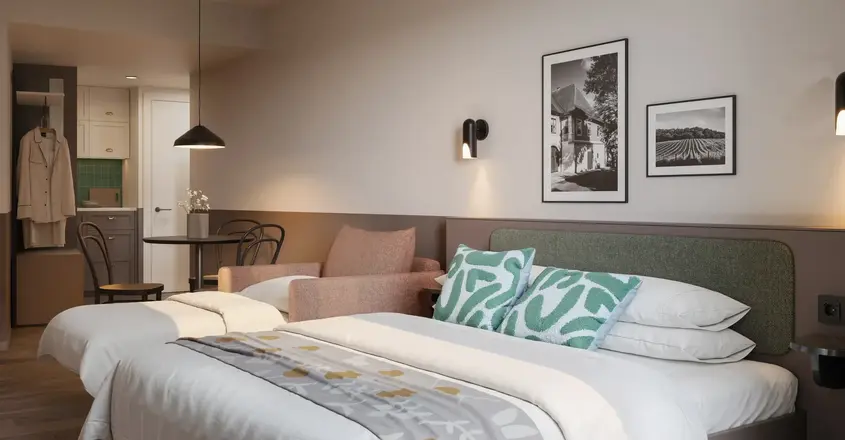 a bed with pillows and a chair in a room