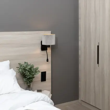 a bed with a plant on the side