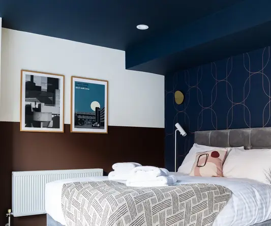 a bed with pillows and blankets in a room