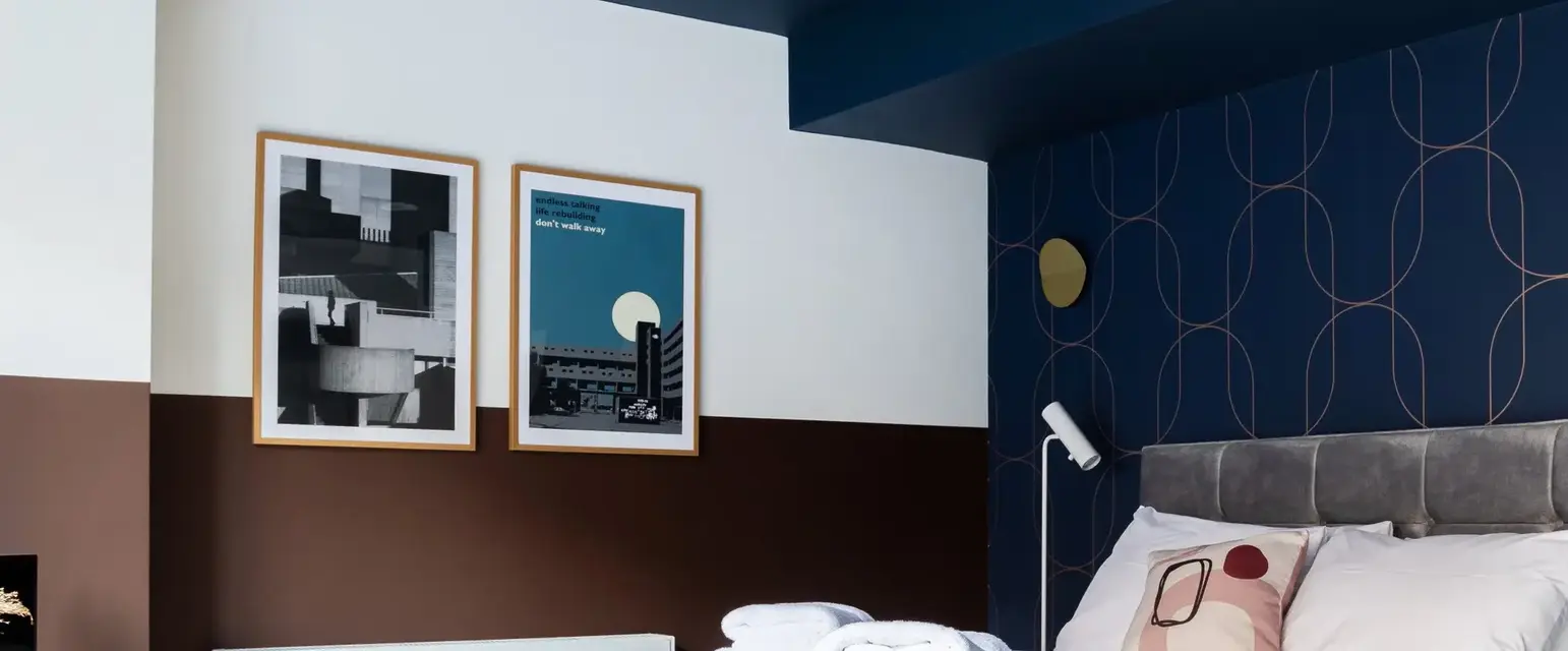 a bed with pillows and blankets in a room