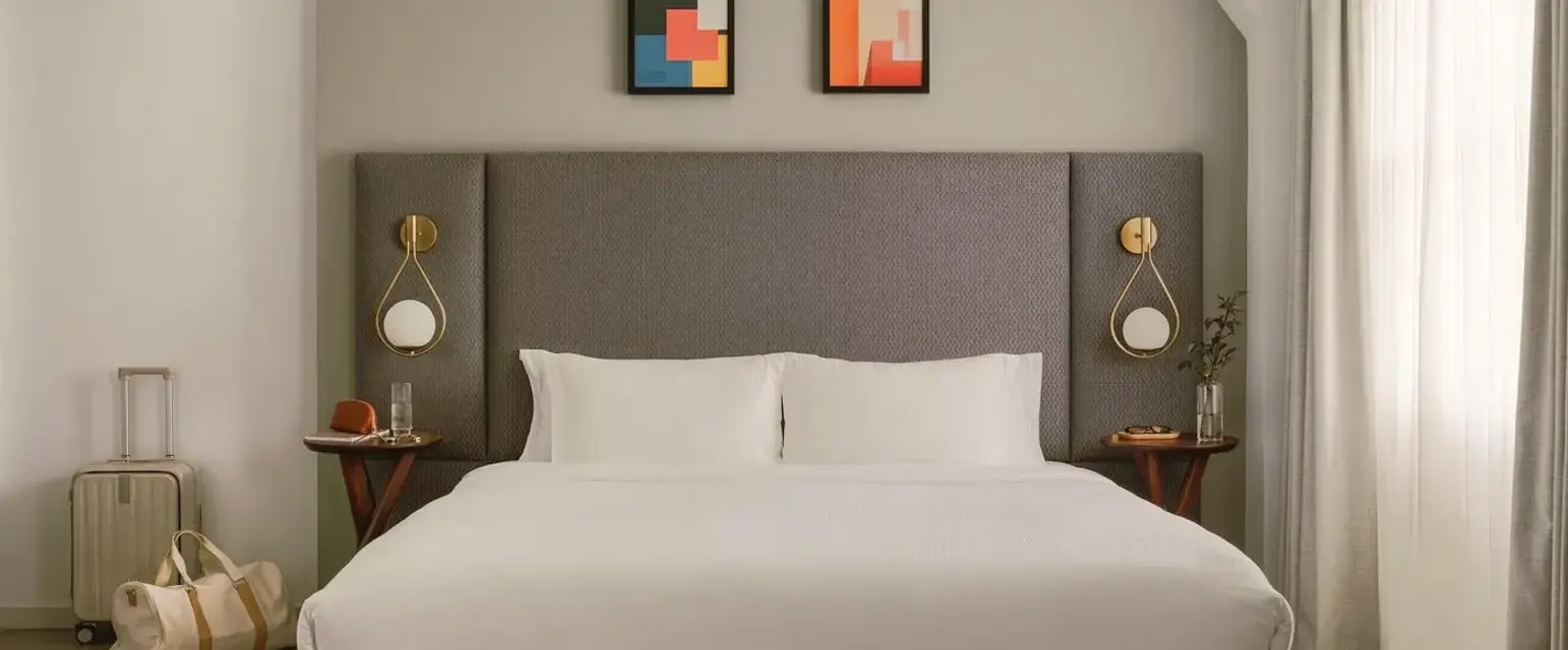 a bed with a headboard and a lamp