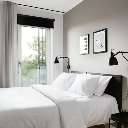 a bed with white sheets and pillows