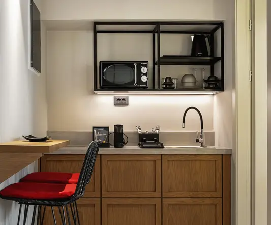 a kitchen with a bar stool and a microwave