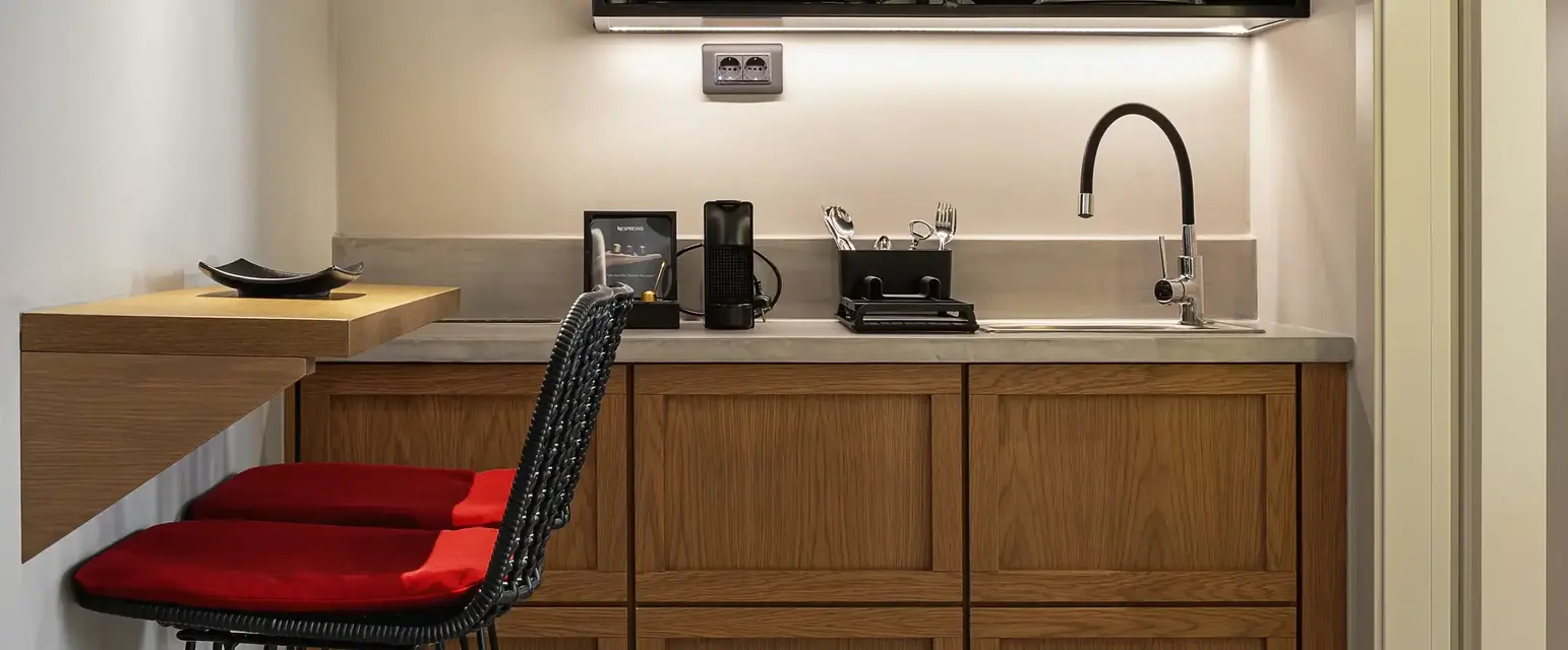 a kitchen with a bar stool and a microwave