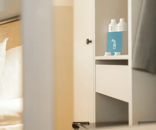 a white shelf with bottles on it