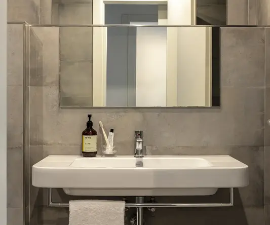 a bathroom with a mirror and a sink