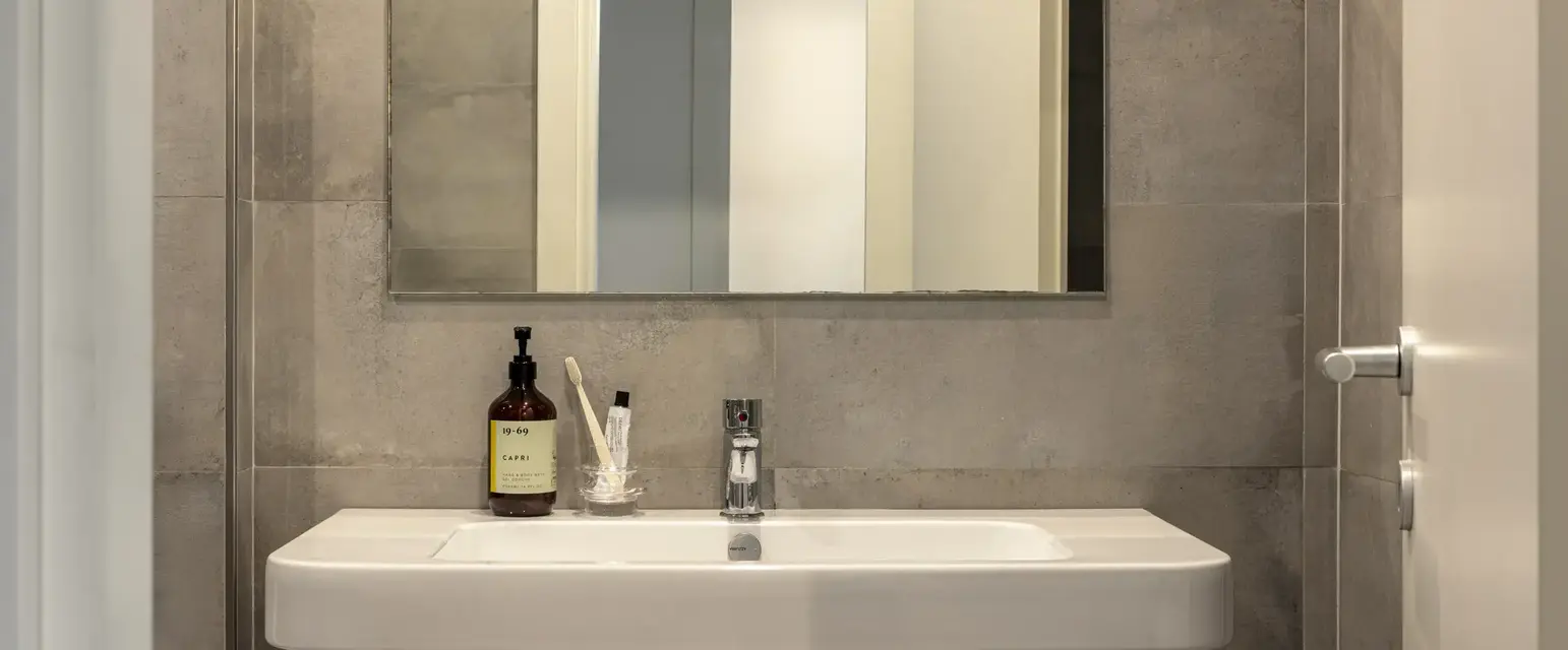 a bathroom with a mirror and a sink