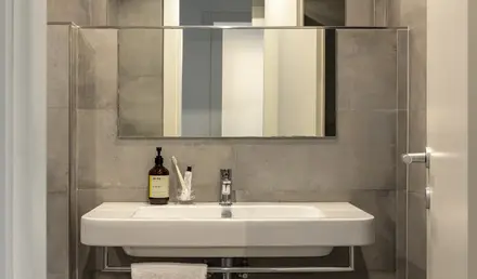 a bathroom with a mirror and a sink