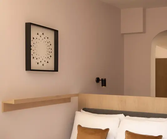 a bed with pillows in a room