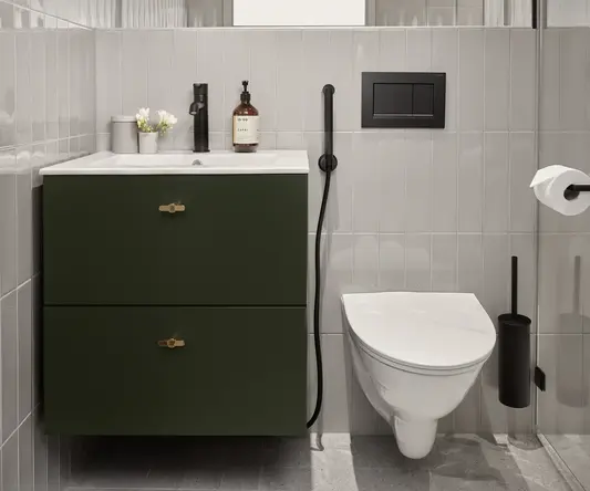 a bathroom with a green sink and toilet