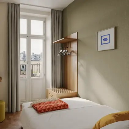 a bedroom with a bed and a window