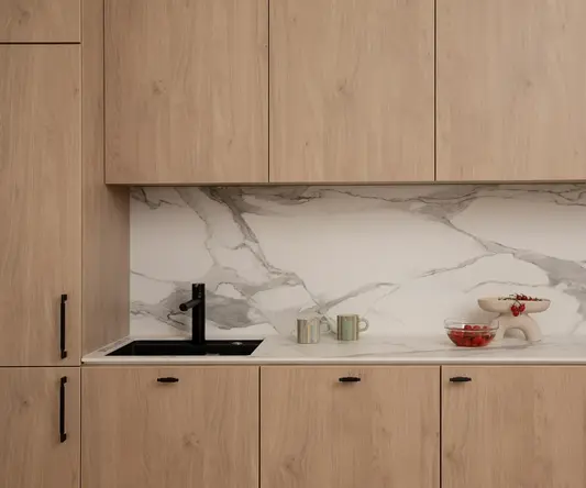 a kitchen counter with wood cabinets and a sink