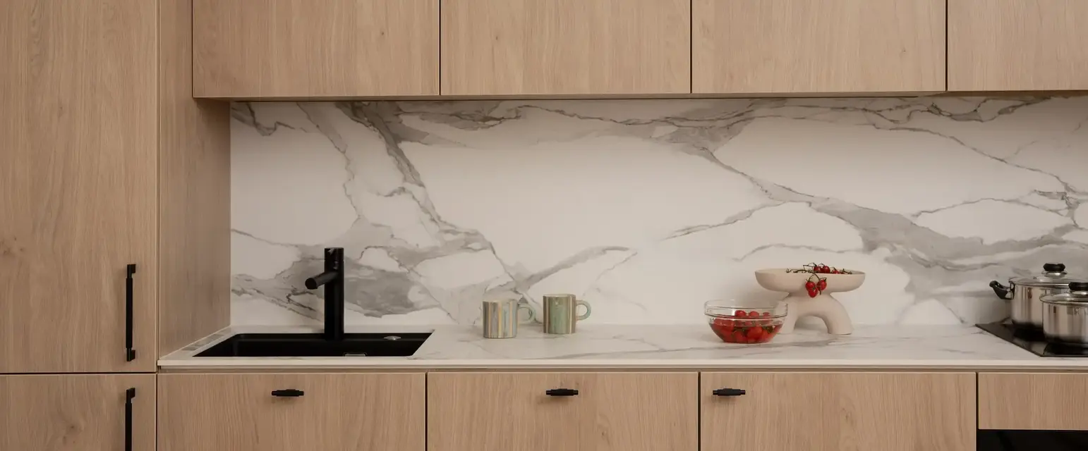 a kitchen counter with wood cabinets and a sink