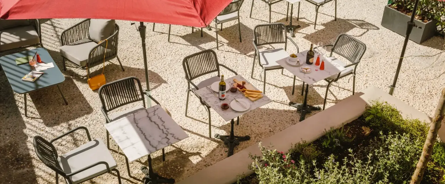 a table and chairs under umbrellas