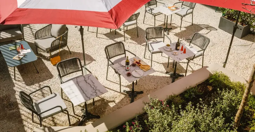 a table and chairs under umbrellas