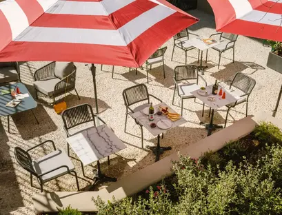 a table and chairs under umbrellas