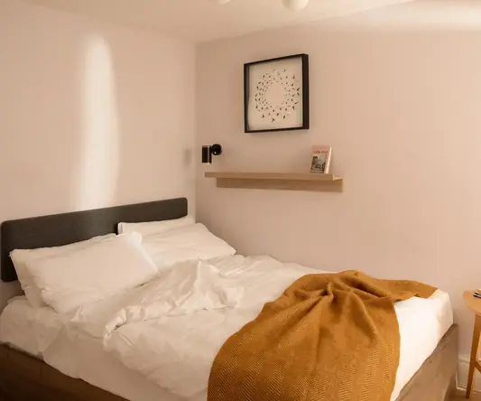 a bed with a blanket and a table