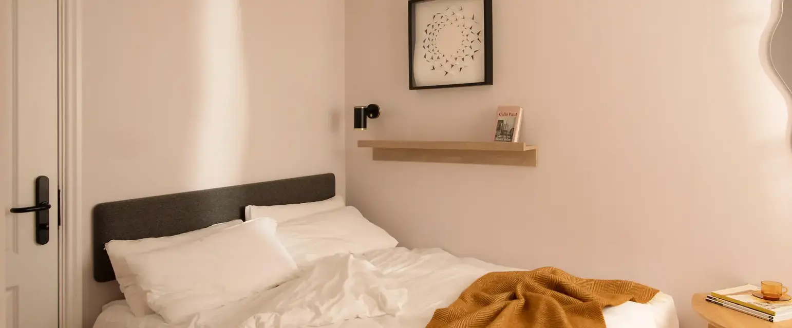 a bed with a blanket and a table