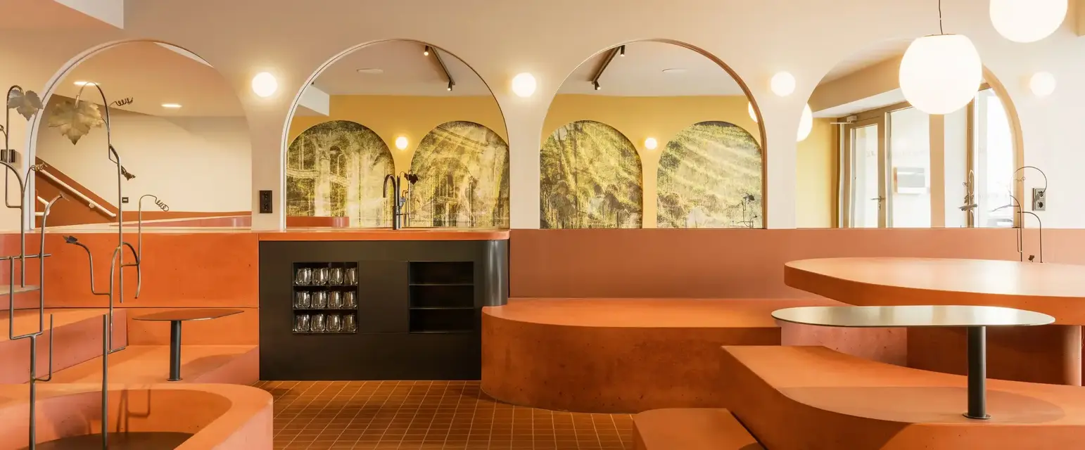 a room with orange benches and a black counter