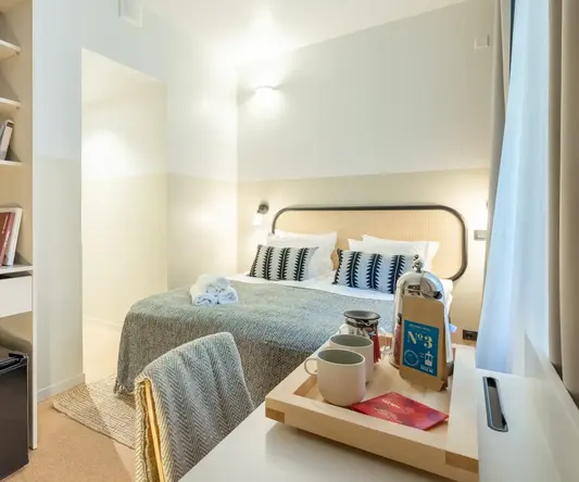 a room with a bed and a desk