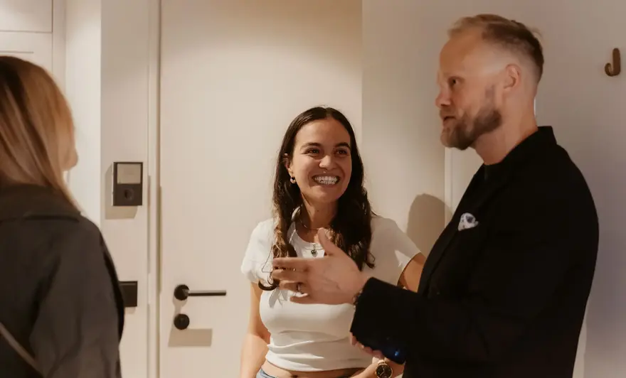 a man and woman standing in a hallway