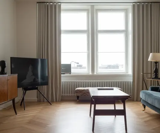 a living room with a tv and a table