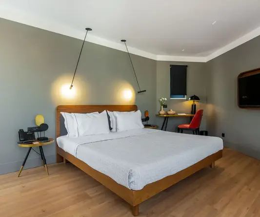 a bed with a wood headboard and a wood floor