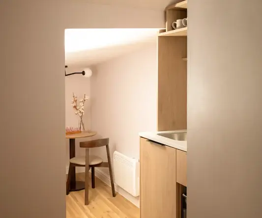 a kitchen with a table and chairs