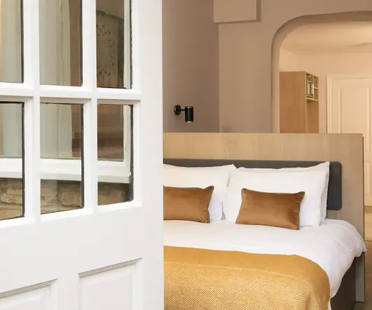 a white door with glass windows and a bed