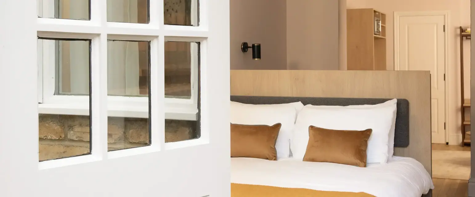 a white door with glass windows and a bed