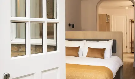 a white door with glass windows and a bed