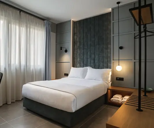 a bed with a lamp and a shelf in a room