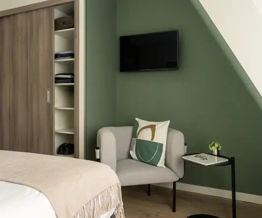 a room with a bed and a chair