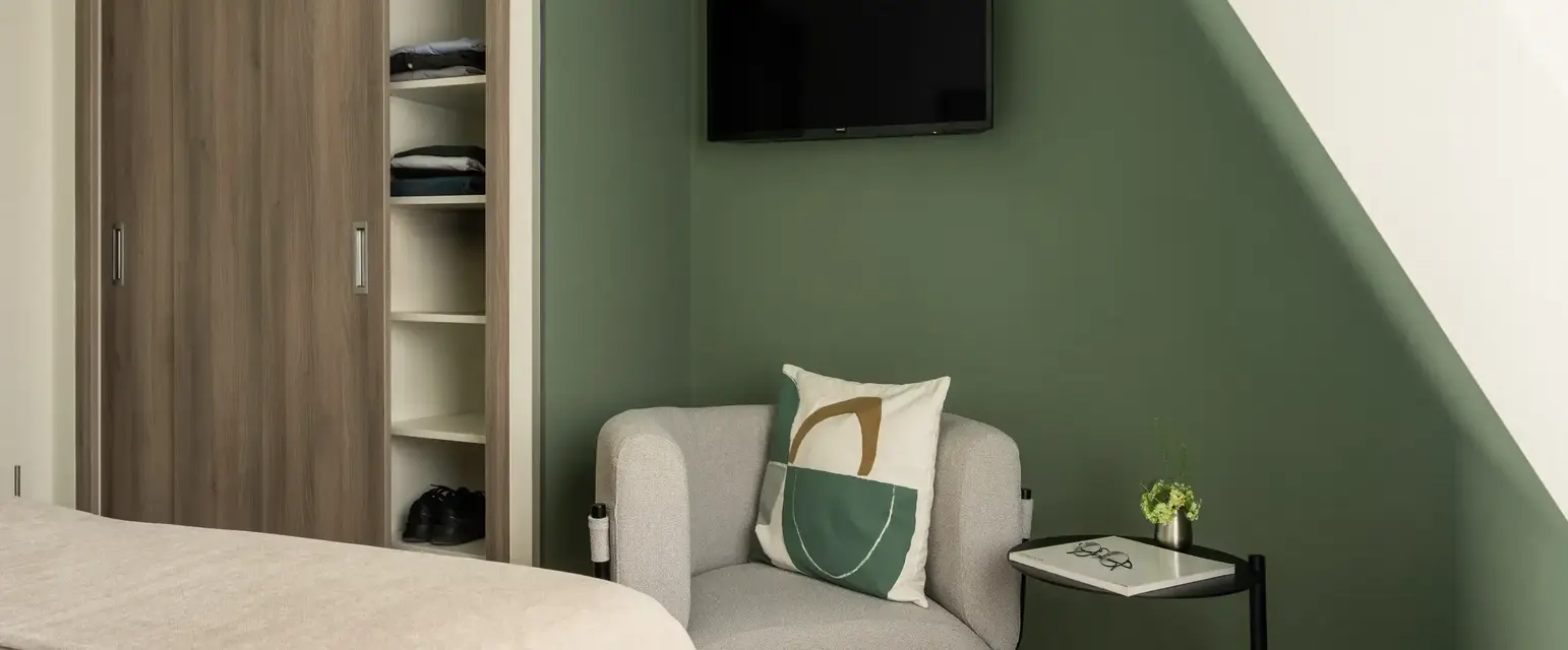 a room with a bed and a chair