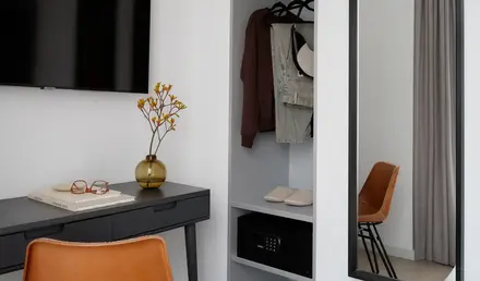 a room with a mirror and a shelf