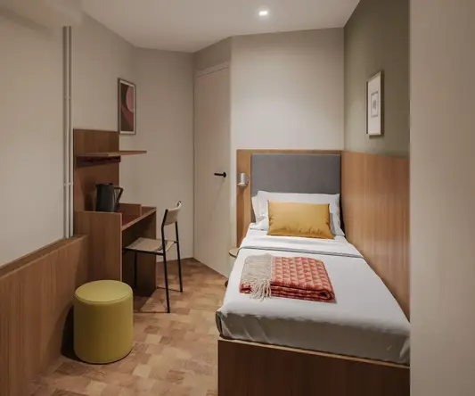 a small room with a bed and desk
