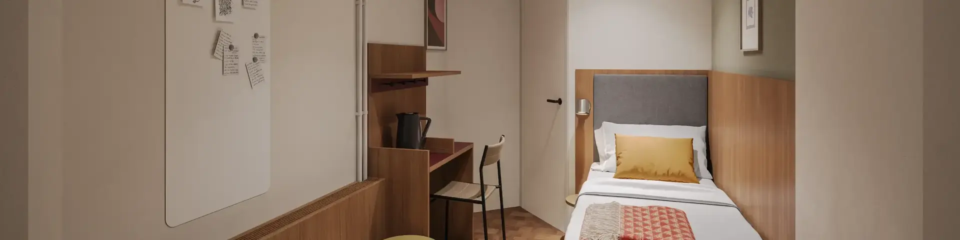 a small room with a bed and desk