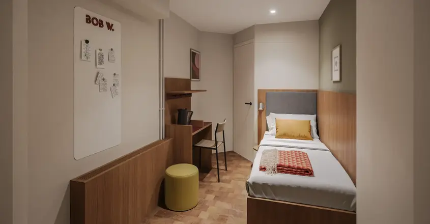 a small room with a bed and desk