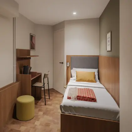 a small room with a bed and desk