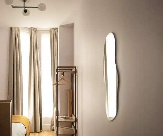 a room with a bed and a mirror