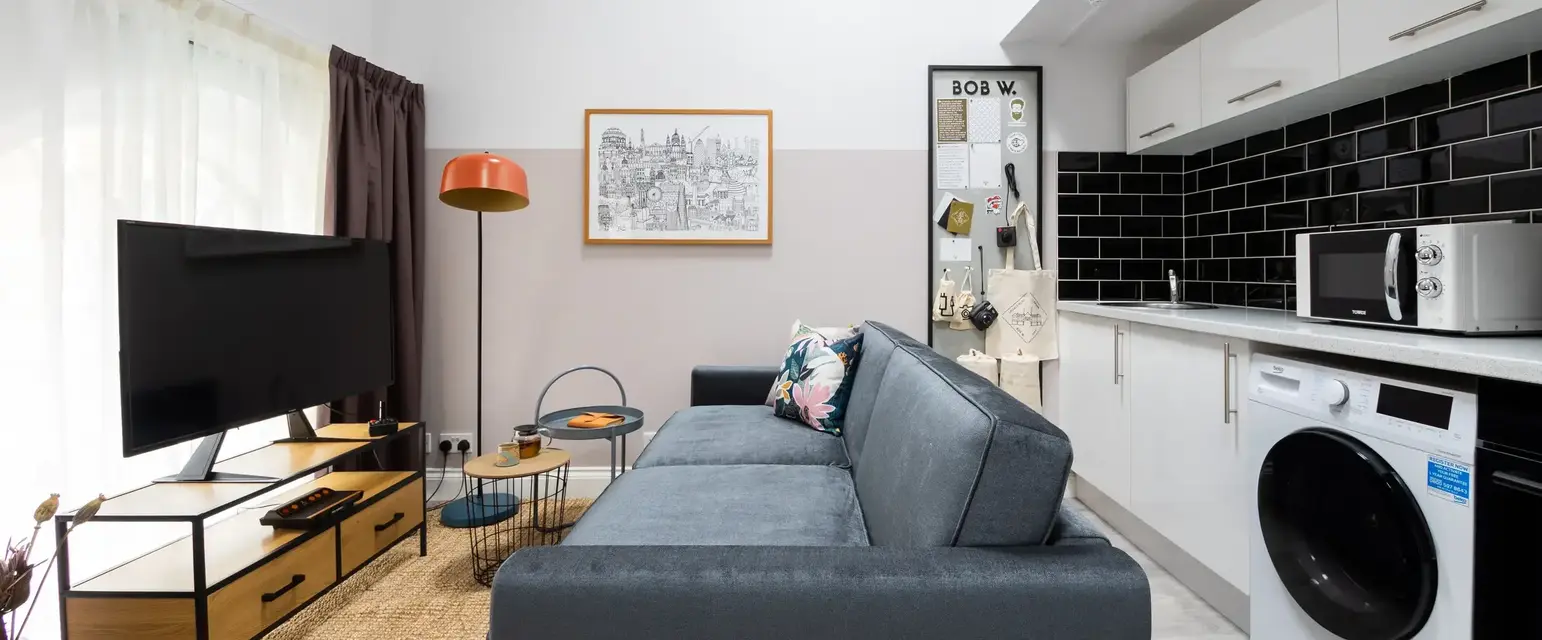 a living room with a couch and a washing machine