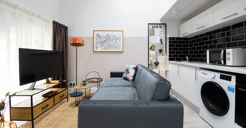 a living room with a couch and a washing machine
