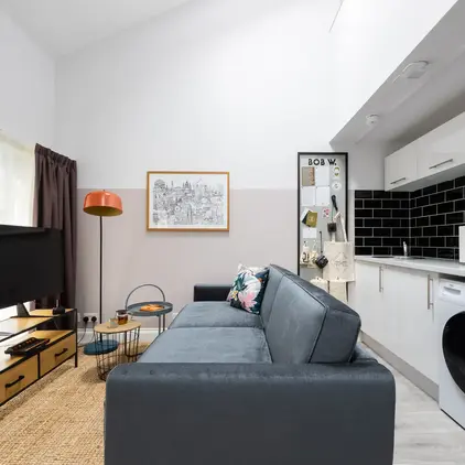 a living room with a couch and a washing machine