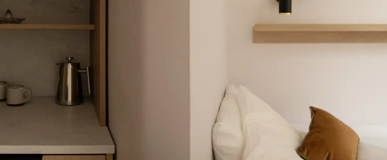 a bed with pillows and a microwave in a room