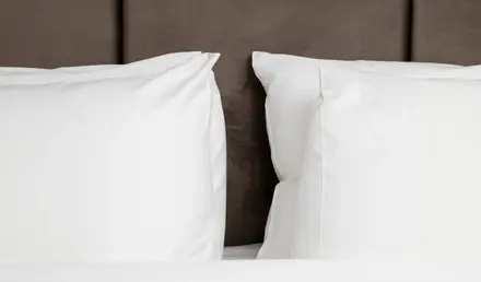 a bed with white pillows