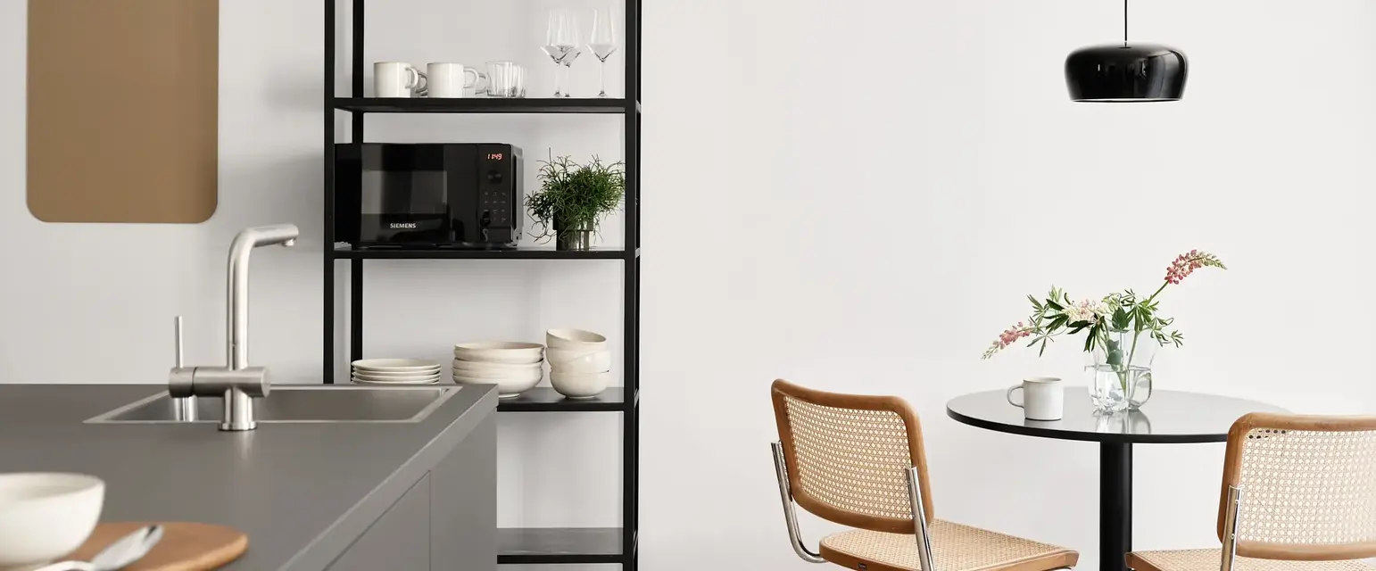 a kitchen with a table and chairs